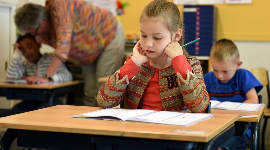 The Importance of School Cleanliness. Child sitting at desk in school